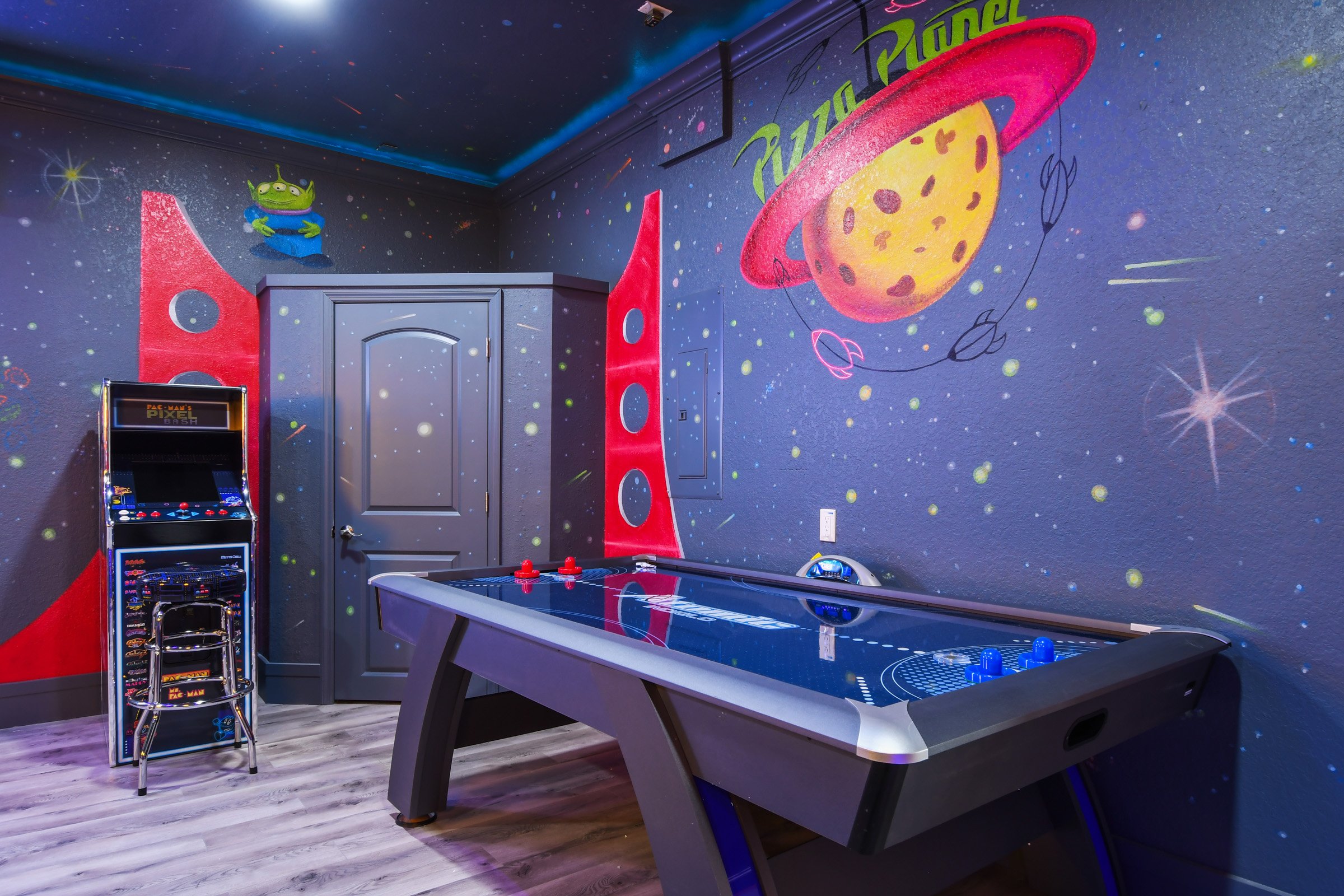 Pizza Planet game room with arcade and pinball