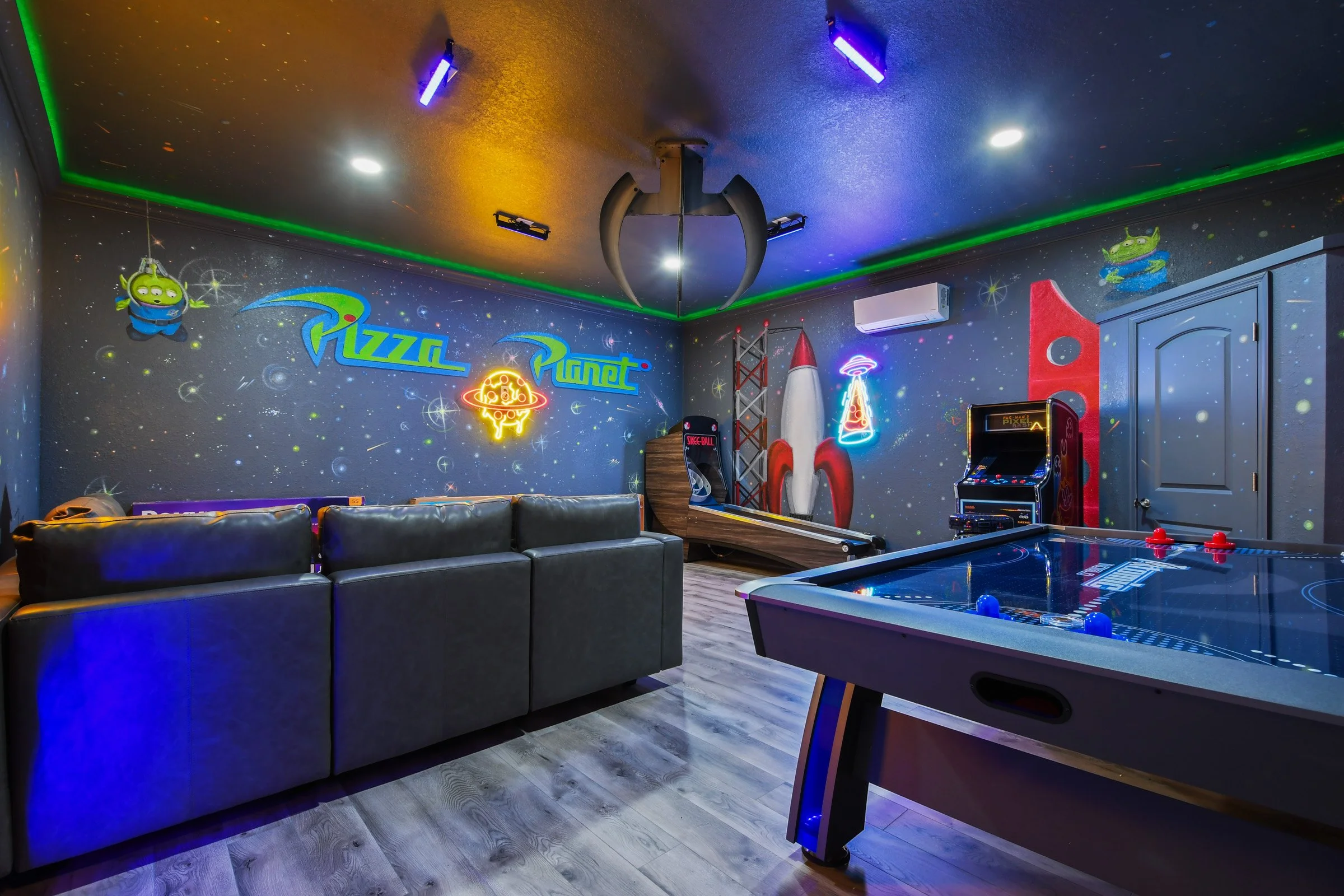 Pizza Planet themed game room with arcade, pinball, and air hockey at Time-Out Corner, Too — Windsor Hills vacation rental