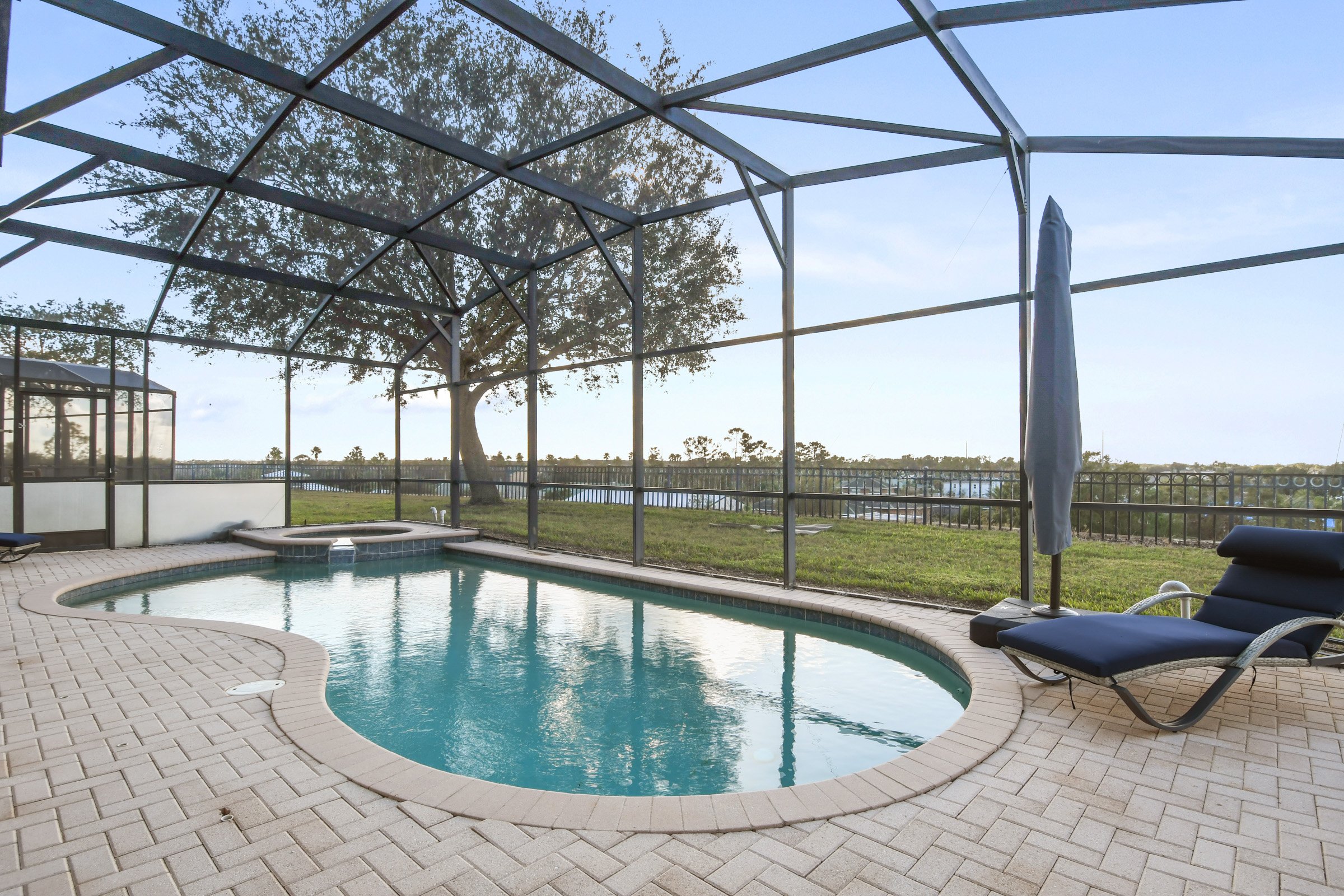 Screened lanai with heated saltwater pool and hilltop sunset views