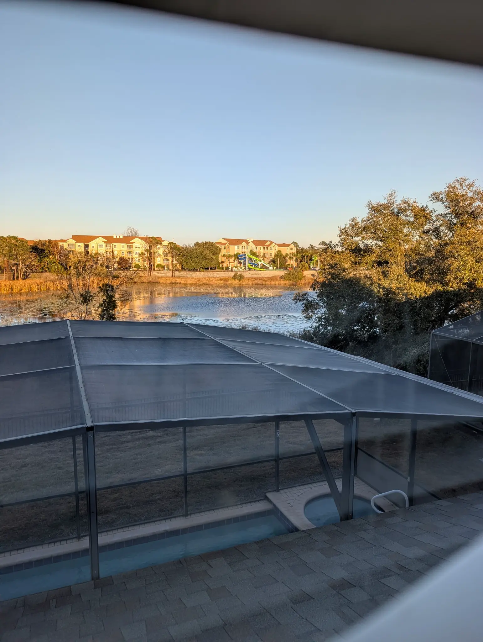Lakefront view from Time-Out Corner, Lakeside — Windsor Hills lake with Disney fireworks visible from the lanai