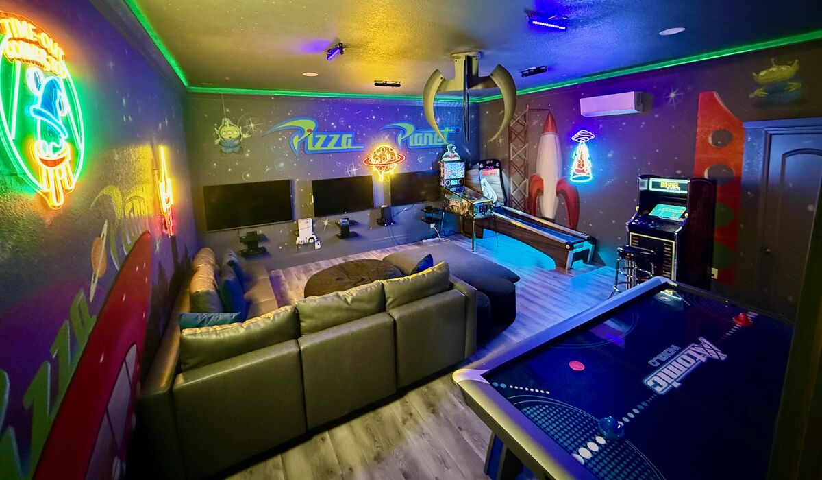Pizza Planet game room glowing under neon and LED lights