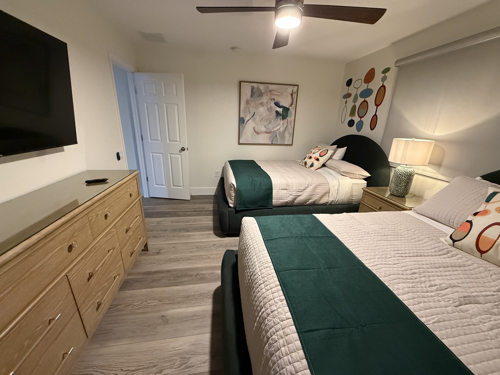 Double bedroom with two full beds, dresser, and TV at Time-Out Corner, Lakeside