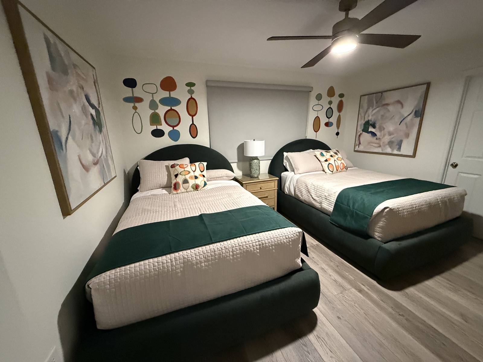 Double bedroom with two full beds and modern art at Time-Out Corner, Lakeside