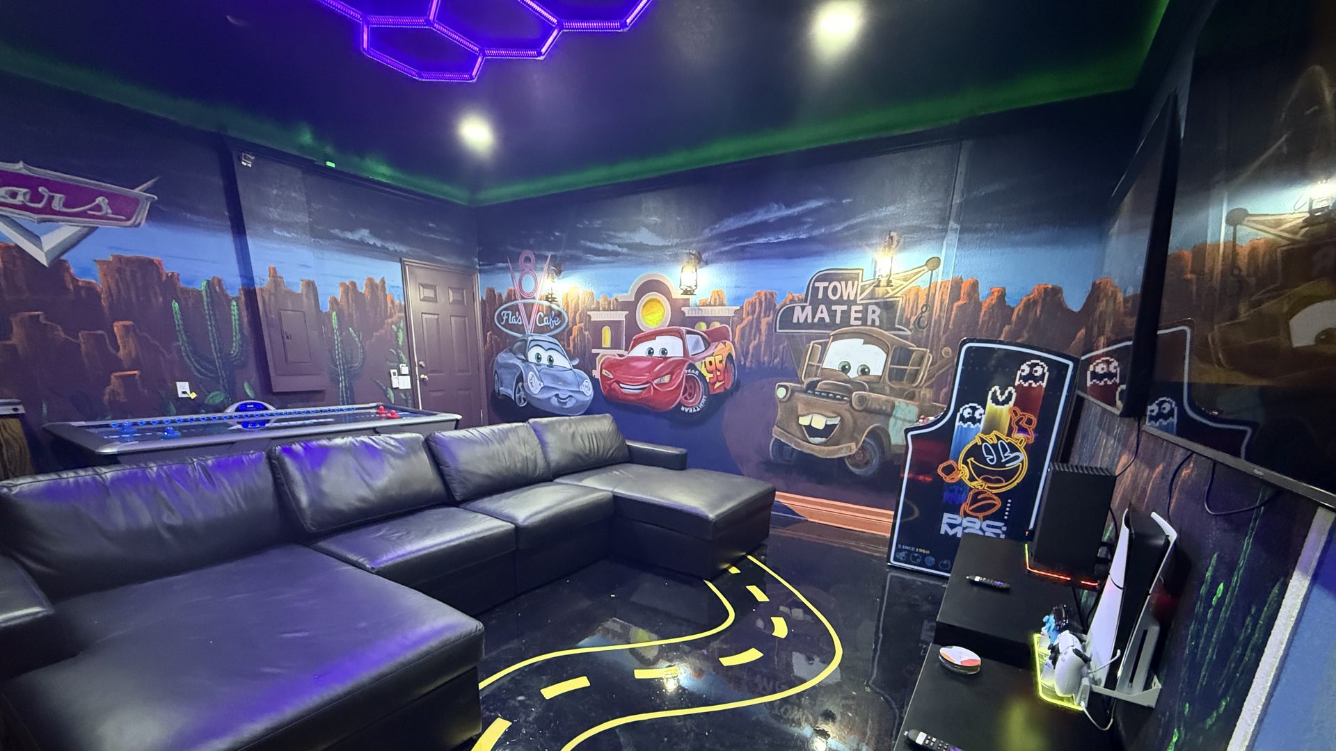 Radiator Springs themed game room with hand-painted Cars murals, Pac-Man arcade, and gaming stations at Time-Out Corner, Lakeside