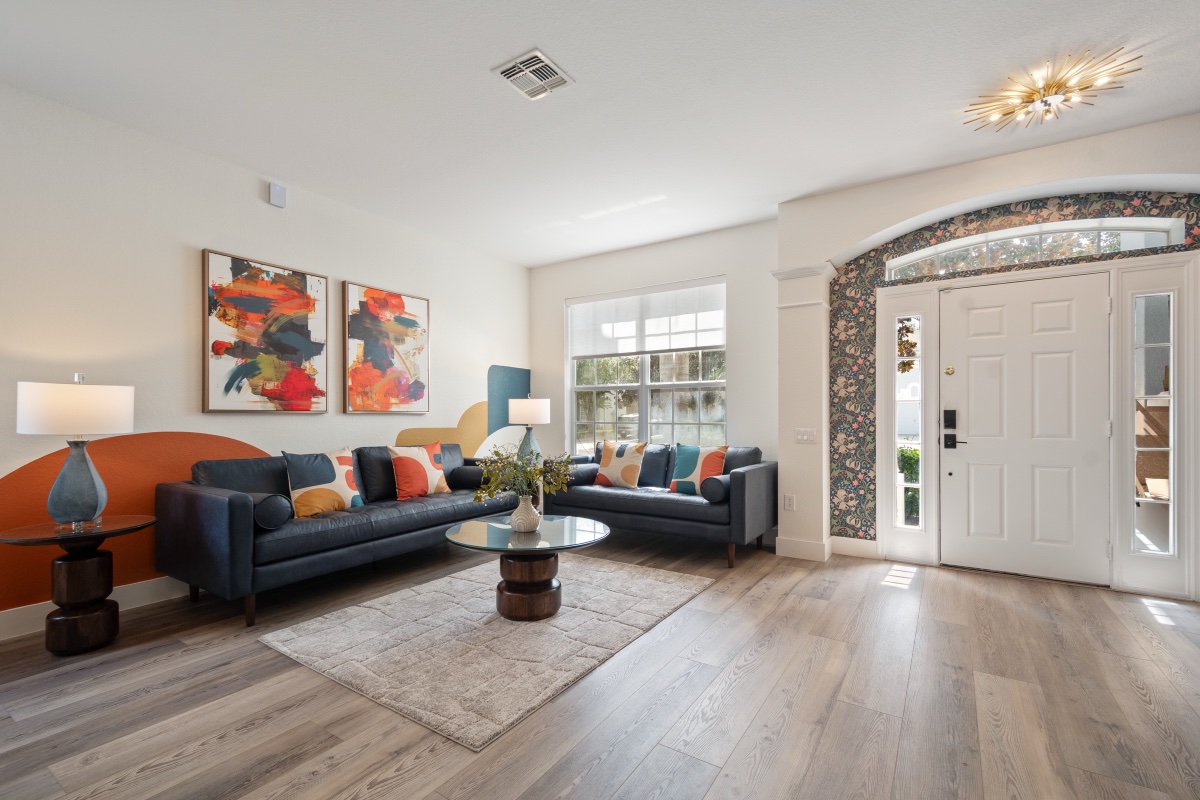 Living room with leather sofas and colorful art near the front entry at Time-Out Corner, Lakeside