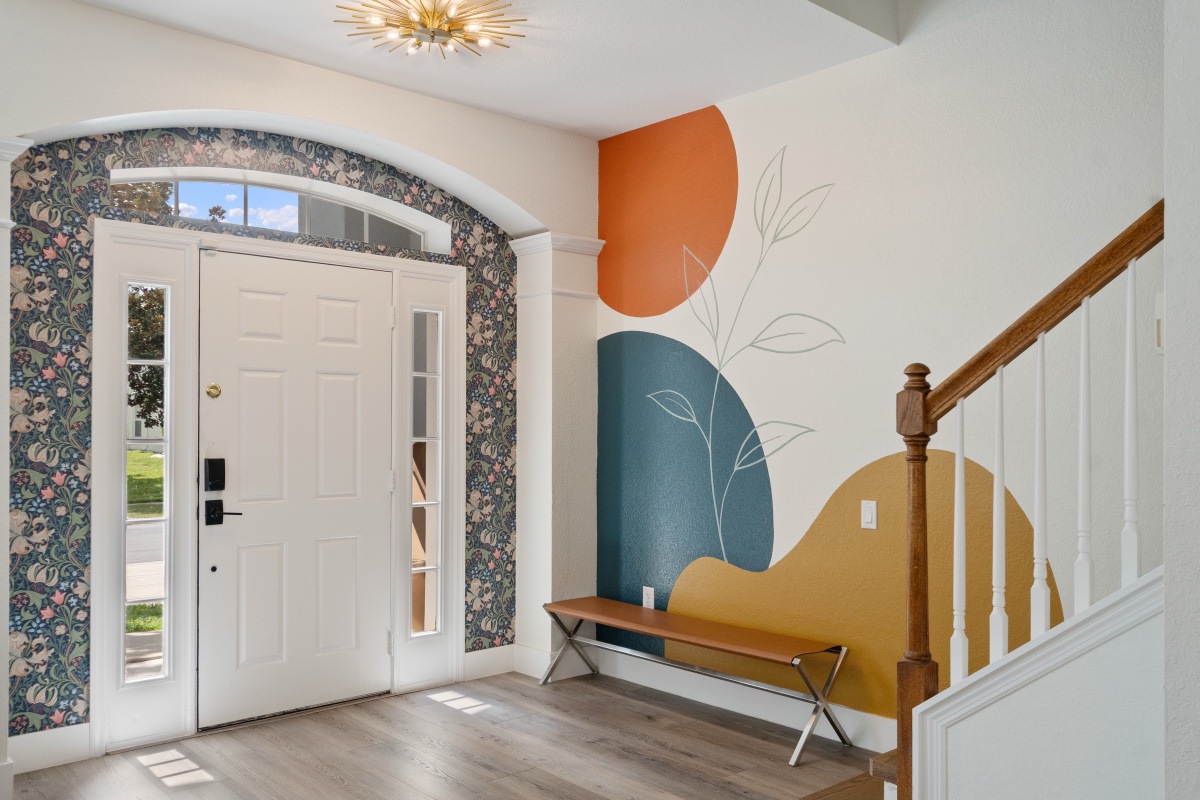 Front foyer with mural accent wall and staircase at Time-Out Corner, Lakeside