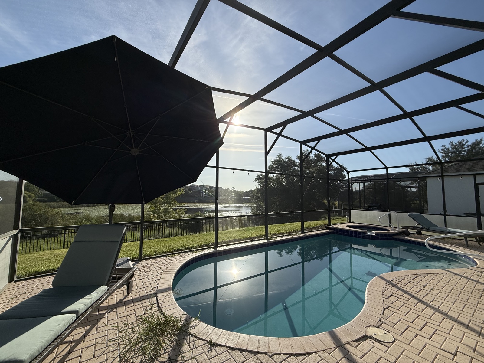 Screened pool and spa with sun umbrella at Time-Out Corner, Lakeside
