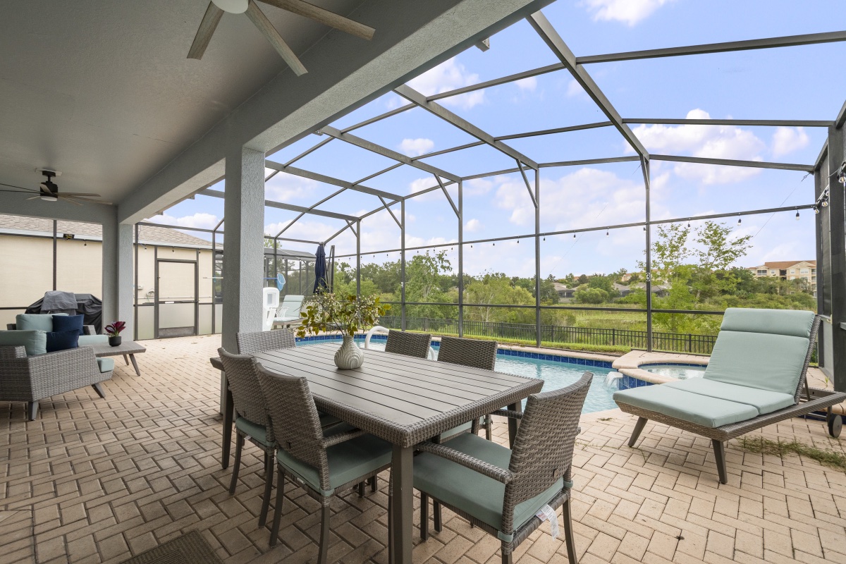 Covered lanai with outdoor dining table and pool view at Time-Out Corner, Lakeside