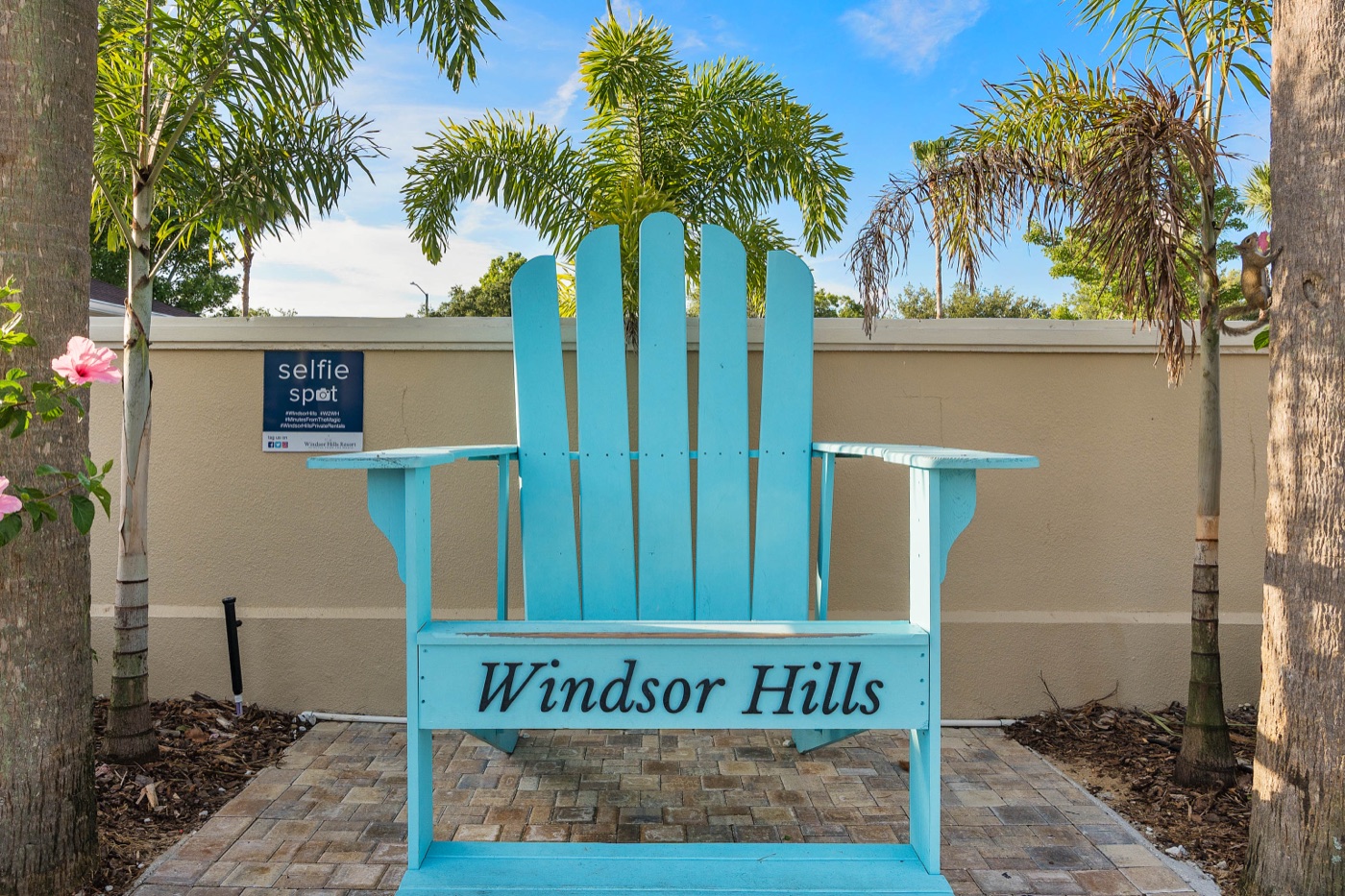 Blue lounge chairs beside the pool with the Windsor Hills sign