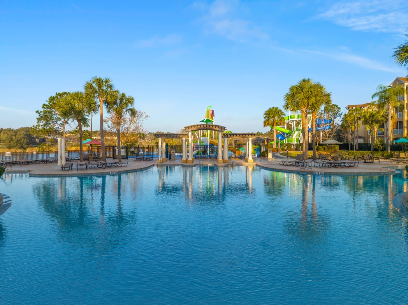 Zero-entry resort pool lined with palm trees at Windsor Hills