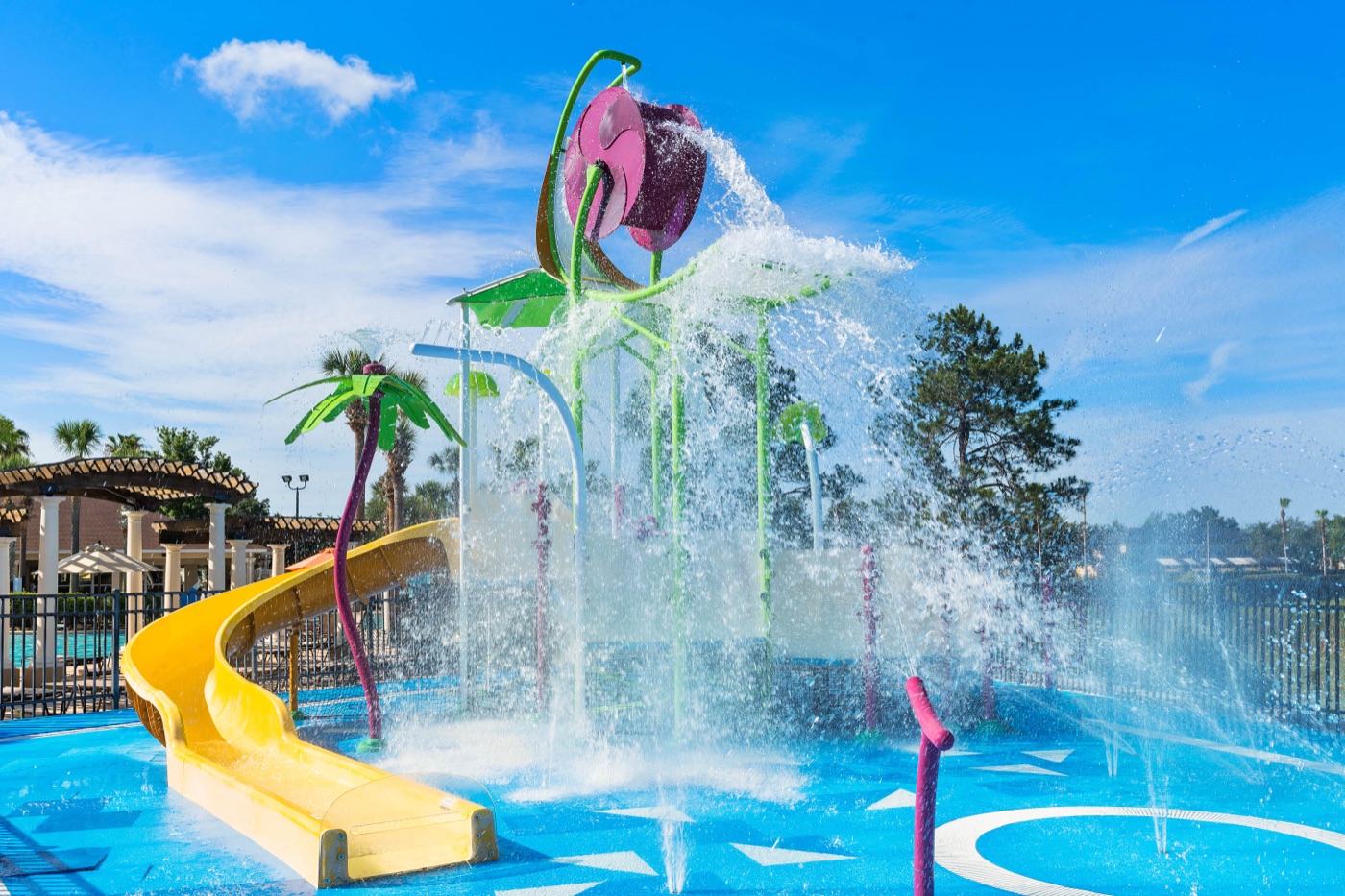 Palm-tree splash structures spraying water at the Windsor Hills splash pool